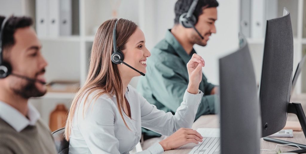 Customer service team with headsets in a modern office, ensuring reliable Melbourne transport and delivery solutions.